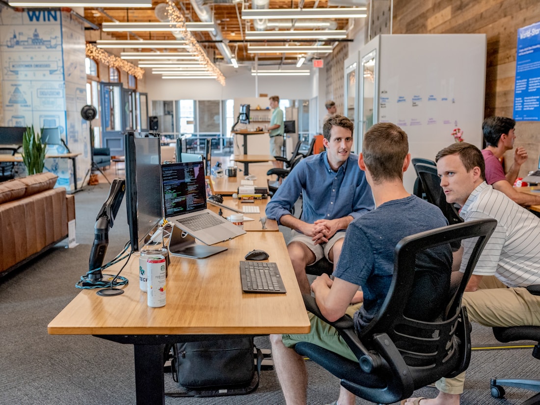 Business operations team collaborating around a laptop